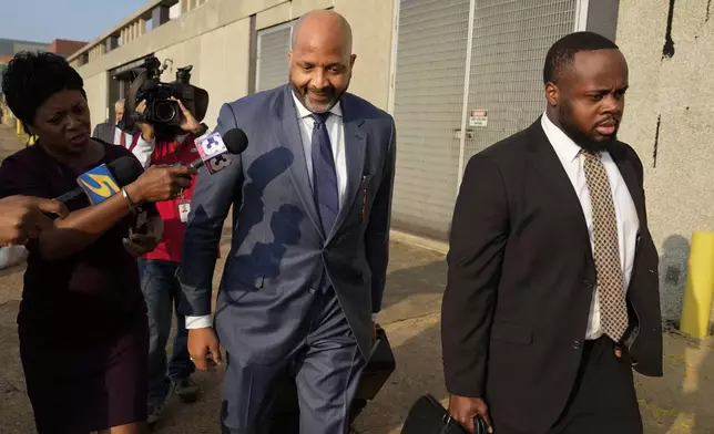 Attorney John Keith Perry, center, leaves the federal courthouse with his client former Memphis police officer Tadarrius Bean after the first day of jury selection of the trial in the Tyre Nichols case Monday, Sept. 9, 2024, in Memphis, Tenn. (AP Photo/George Walker IV)