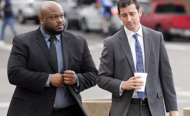 Former Memphis police officer Desmond Mills, left, arrives at the federal courthouse with his attorney Blake Ballin, right, to testify against his former colleagues during the trial in the Tyre Nichols case Wednesday, Sept. 25, 2024, in Memphis, Tenn. (AP Photo/George Walker IV)