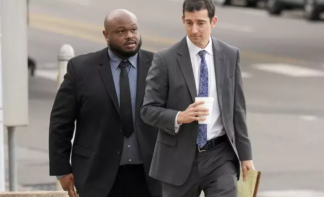 Former Memphis police officer Desmond Mills, left, arrives at the federal courthouse with his attorney Blake Ballin, right, to testify against his former colleagues during the trial in the Tyre Nichols case Wednesday, Sept. 25, 2024, in Memphis, Tenn. (AP Photo/George Walker IV)