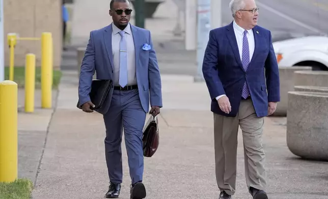 Former Memphis police officer Justin Smith, left, and attorney Martin Zummach, right, arrive at the federal courthouse for the second day of jury selection for the trial in the Tyre Nichols case Tuesday, Sept. 10, 2024, in Memphis, Tenn. (AP Photo/George Walker IV)