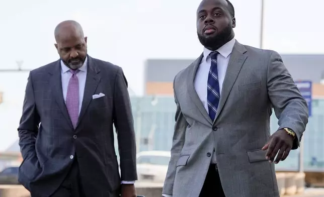 Former Memphis police officer Tadarrius Bean, right, arrives at the federal courthouse with attorney John Keith Perry, right, for the second day of jury selection for the trial in the Tyre Nichols case Tuesday, Sept. 10, 2024, in Memphis, Tenn. (AP Photo/George Walker IV)