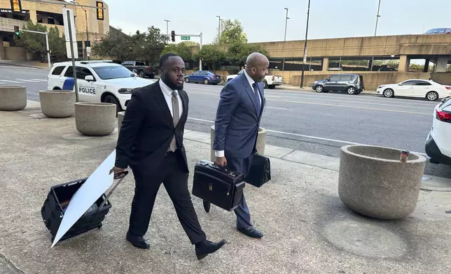 Former Memphis police officer Tadarrius Bean, left, and his lawyer John Keith Perry walk towards the entrance of a federal courthouse before the start of jury selection of the trial in the Tyre Nichols case on Monday, Sept. 9, 2024, in Memphis, Tenn. (AP Photo/Adrian Sainz)