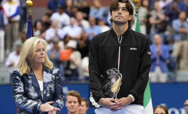 Taylor Fritz, of the United States, holds the finalist trophy after losing to Jannik Sinner, of Italy, in the men's singles final of the U.S. Open tennis championships, Sunday, Sept. 8, 2024, in New York. (AP Photo/Kirsty Wigglesworth)