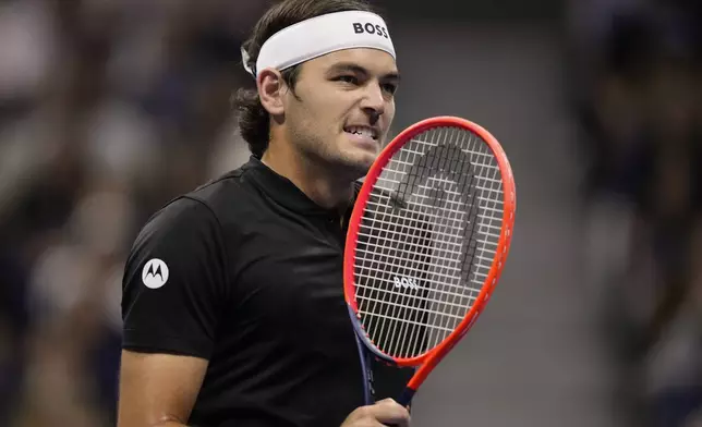 Taylor Fritz, of the United States, returns a shot to Frances Tiafoe, of the United States, during the men's singles semifinal of the U.S. Open tennis championships, Friday, Sept. 6, 2024, in New York. (AP Photo/Frank Franklin II)