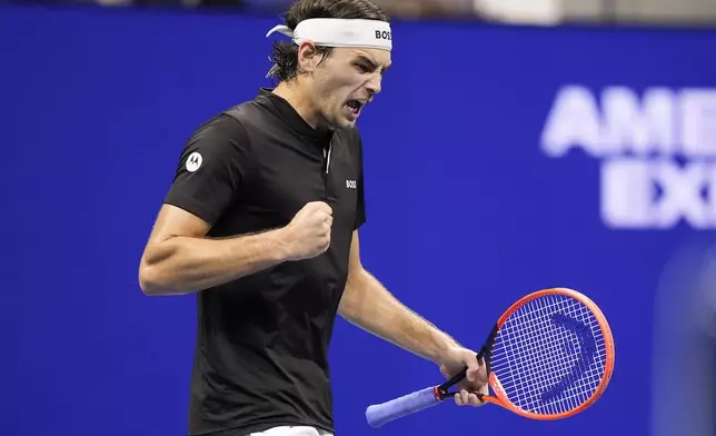 Taylor Fritz, of the United States, reacts after winning the fourth set against Frances Tiafoe, of the United States, during the men's singles semifinal of the U.S. Open tennis championships, Friday, Sept. 6, 2024, in New York. (AP Photo/Frank Franklin II)