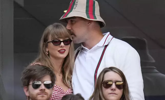 Taylor Swift, left, and Travis Kielce watch play between Jannik Sinner, of Italy, and Taylor Fritz, of the United States, during the men's singles final of the U.S. Open tennis championships, Sunday, Sept. 8, 2024, in New York. (AP Photo/Kirsty Wigglesworth)