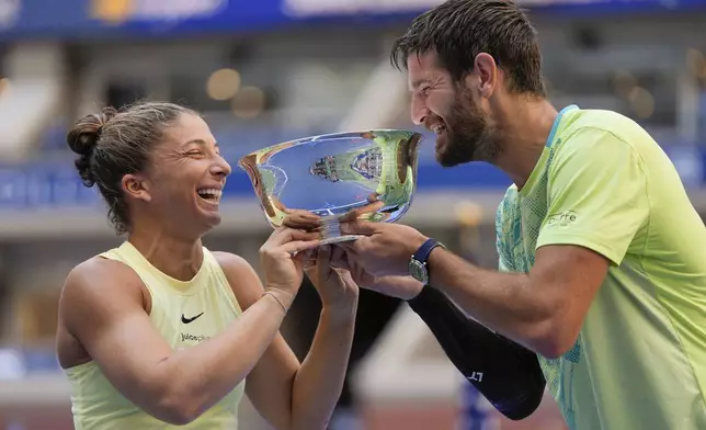 Sara Errani, of Italy, and Andrea Vavassori, of Italy, hold up the championship trophy after defeating Taylor Townsend, of the United States, and Donald Young, of the United States, in the mixed doubles final of the U.S. Open tennis championships, Thursday, Sept. 5, 2024, in New York. (AP Photo/Julia Nikhinson)