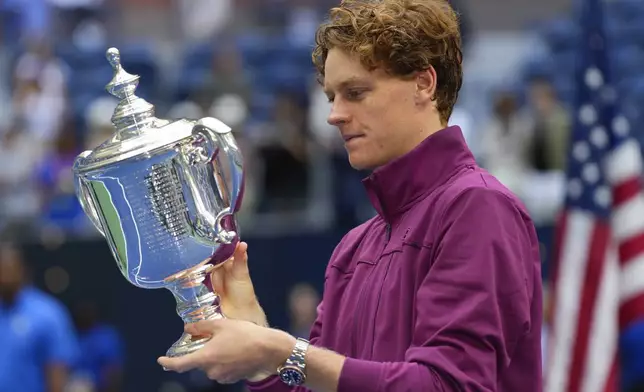 Jannik Sinner, of Italy, holds the championship trophy after defeating Taylor Fritz, of the United States, in the men's singles final of the U.S. Open tennis championships, Sunday, Sept. 8, 2024, in New York. (AP Photo/Kirsty Wigglesworth)