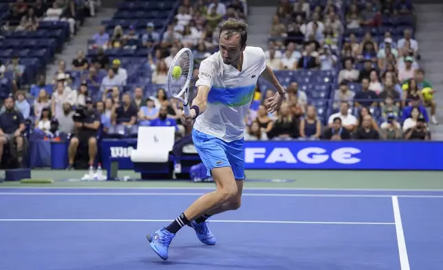 Daniil Medvedev, of Russia, returns a shot to Flavio Cobolli, of Italy, during the third round of the U.S. Open tennis championships, Saturday, Aug. 31, in New York. 2024. (AP Photo/Matt Rourke)