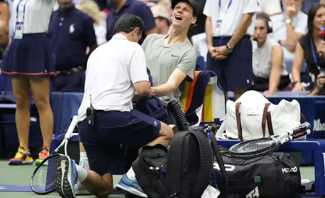 Jannik Sinner, of Italy, is examined during the men's singles semifinals against Jack Draper, of Great Britain, of the U.S. Open tennis championships, Friday, Sept. 6, 2024, in New York. (AP Photo/Kirsty Wigglesworth)