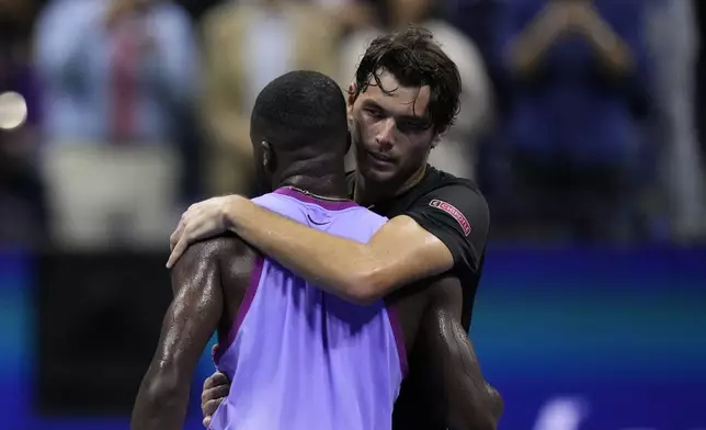 Taylor Fritz, of the United States, hugs Frances Tiafoe, of the United States, after winning the men's singles semifinals of the U.S. Open tennis championships, Friday, Sept. 6, 2024, in New York. (AP Photo/Kirsty Wigglesworth)