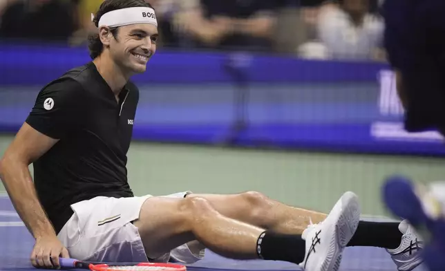 Taylor Fritz, of the United States, reacts after falling on the court in the first set against Frances Tiafoe, of the United States, during the men's singles semifinal of the U.S. Open tennis championships, Friday, Sept. 6, 2024, in New York. (AP Photo/Frank Franklin II)