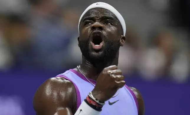 Frances Tiafoe, of the United States, reacts after breaking the serve of Taylor Fritz, of the United States, during the men's singles semifinals of the U.S. Open tennis championships, Friday, Sept. 6, 2024, in New York. (AP Photo/Seth Wenig)