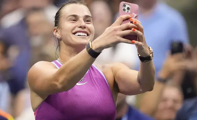 Aryna Sabalenka, of Belarus, records images after defeating Jessica Pegula, of the United States, in the women's singles final of the U.S. Open tennis championships, Saturday, Sept. 7, 2024, in New York. (AP Photo/Julia Nikhinson)