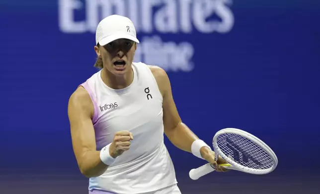 =Iga Swiatek, of Poland, reacts against Liudmila Samsonova, of Russia, during a fourth round match of the U.S. Open tennis championships, Monday, Sept. 2, 2024, in New York. (AP Photo/Adam Hunger)