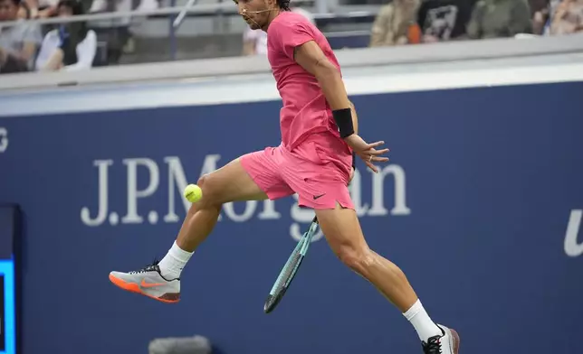 Lorenzo Musetti, of Italy, returns a shot to Brandon Nakashima, of the United States, during a third round match of the U.S. Open tennis championships, Friday, Aug. 30, 2024, in New York. (AP Photo/Frank Franklin II)