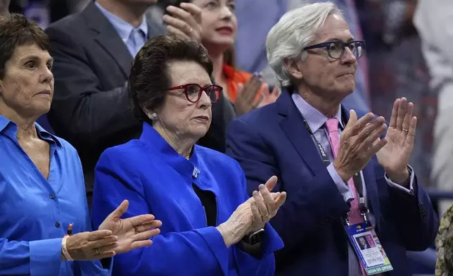 Billie Jean King, center, her wife Ilana Kloss and USTA president Brian Hainline, arrives for the women's singles final of the U.S. Open tennis championships between Aryna Sabalenka, of Belarus, and Jessica Pegula, of the United States, Saturday, Sept. 7, 2024, in New York. (AP Photo/Frank Franklin II)