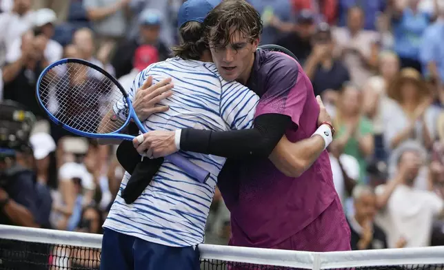 Jack Draper, of Great Britain, right, hugs Alex de Minaur, of Australia, after winning their quarterfinal match of the U.S. Open tennis championships, Wednesday, Sept. 4, 2024, in New York. (AP Photo/Pamela Smith)