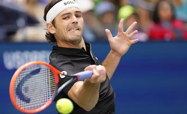 Taylor Fritz, of the United States, returns a shot to Jannik Sinner, of Italy, during the men's singles final of the U.S. Open tennis championships, Sunday, Sept. 8, 2024, in New York. (AP Photo/Kirsty Wigglesworth)