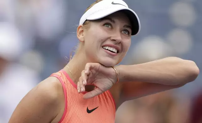 Anastasia Potapova, of Russia, wipes sweat from her face during a match against Karolina Muchova, of the Czech Republic, during the third round of the U.S. Open tennis championships, Saturday, Aug. 31, 2024, in New York. (AP Photo/Adam Huger)