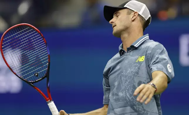 Tommy Paul, of the United States, reacts against Jannik Sinner, of Italy, during a fourth round match of the U.S. Open tennis championships, Monday, Sept. 2, 2024, in New York. (AP Photo/Adam Hunger)