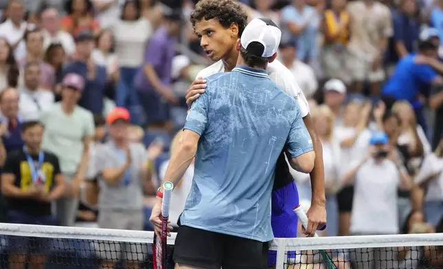 Gabriel Diallo, of Canada,, left, greets Tommy Paul, of the United States, at the net after Paul won their third round match of the U.S. Open tennis championships, Saturday, Aug. 31, 2024, in New York. (AP Photo/Kirsty Wigglesworth)