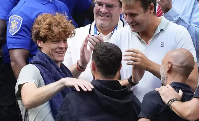 Jannik Sinner, of Italy, celebrates with members of his team after defeating Taylor Fritz, of the United States, in the men's singles final of the U.S. Open tennis championships, Sunday, Sept. 8, 2024, in New York. (AP Photo/Kirsty Wigglesworth)