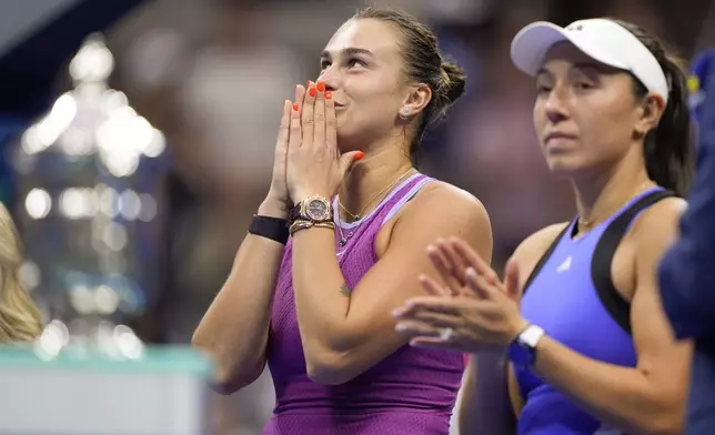 Aryna Sabalenka, of Belarus, left, and Jessica Pegula, of the United States, wait for the start of the trophy ceremony after Sabalenka defeated Pegula in the women's singles final of the U.S. Open tennis championships, Saturday, Sept. 7, 2024, in New York. (AP Photo/Julia Nikhinson)