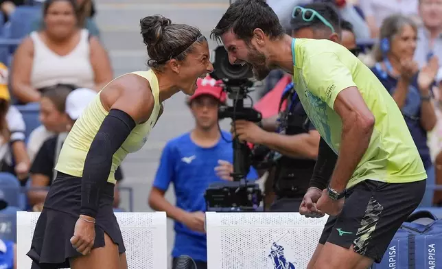 Sara Errani, of Italy, and Andrea Vavassori, of Italy, react after defeating Taylor Townsend, of the United States, and Donald Young, of the United States, in the mixed doubles final of the U.S. Open tennis championships, Thursday, Sept. 5, 2024, in New York. (AP Photo/Julia Nikhinson)