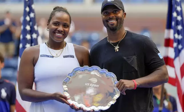 Taylor Townsend, of the United States, and Donald Young, of the United States, hold up the runner-up trophy after losing to Sara Errani, of Italy, and Andrea Vavassori, of Italy, during the mixed doubles final of the U.S. Open tennis championships, Thursday, Sept. 5, 2024, in New York. (AP Photo/Julia Nikhinson)