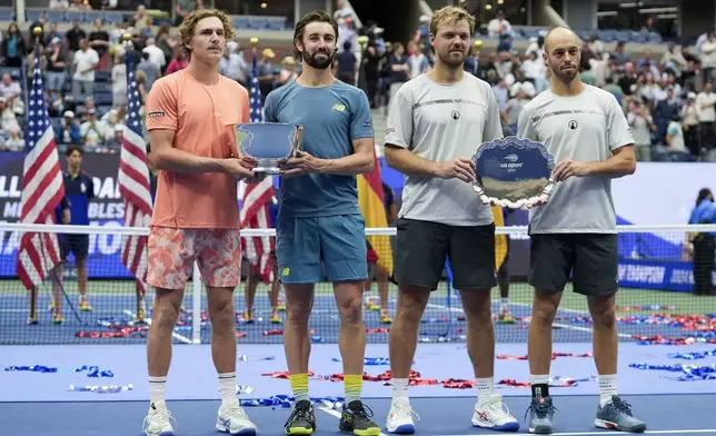 Men's doubles final champions Max Purcell, left, and Jordan Thompson, of Australia, pose for a photo with runners-up Kevin Krawietz, and Tim Puetz, of Germany, after the men's doubles final of the U.S. Open tennis championships, Saturday, Sept. 7, 2024, in New York. (AP Photo/Pamela Smith)