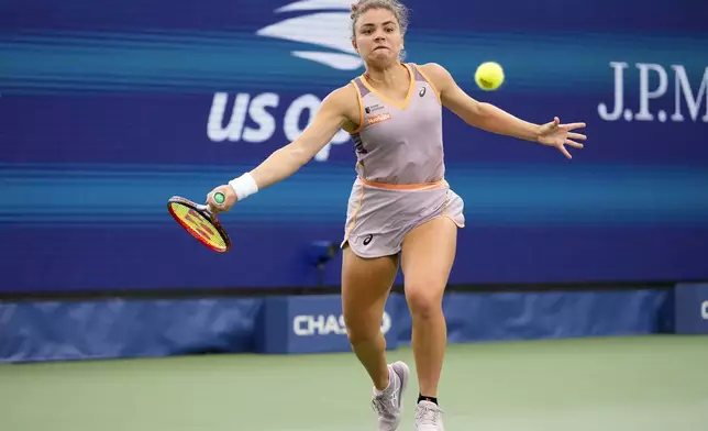 Jasmine Paolini, of Italy, returns a shot to Yulia Putintseva, of Kazakhstan, during the third round of the U.S. Open tennis championships, Saturday, Aug. 31, 2024, in New York. (AP Photo/Kirsty Wigglesworth)