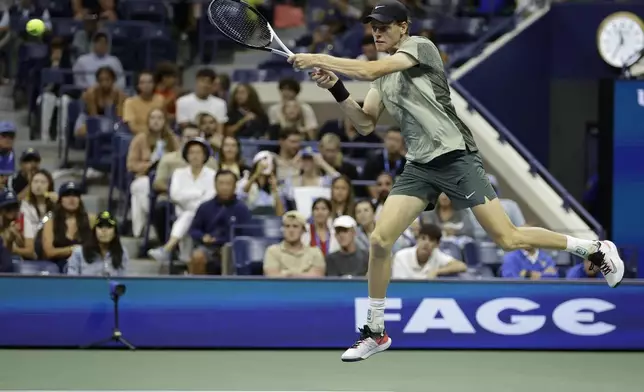 Jannik Sinner, of Italy, returns a shot to Tommy Paul, of the United States, during a fourth round match of the U.S. Open tennis championships, Monday, Sept. 2, 2024, in New York. (AP Photo/Adam Hunger)