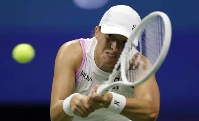 Iga Swiatek, of Poland, returns a shot to Liudmila Samsonova, of Russia, during a fourth round match of the U.S. Open tennis championships, Monday, Sept. 2, 2024, in New York. (AP Photo/Adam Hunger)