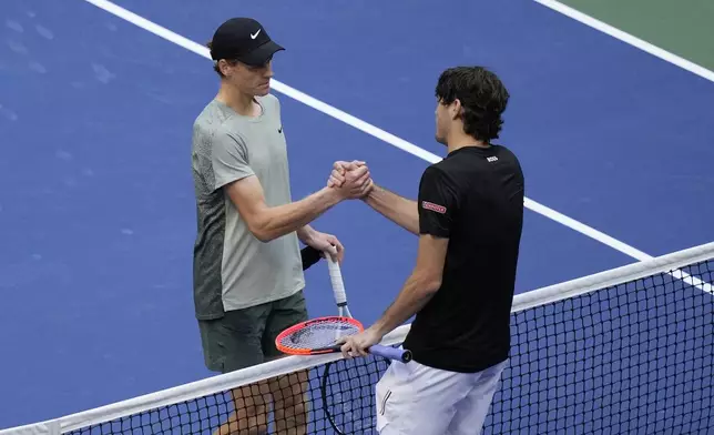 Jannik Sinner, left, of Italy, greets Taylor Fritz, of the United States, after winning the men's singles final of the U.S. Open tennis championships, Sunday, Sept. 8, in New York. 2024. (AP Photo/Frank Franklin II)