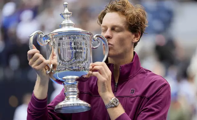 Jannik Sinner, of Italy, kisses the championship trophy after defeating Taylor Fritz, of the United States, in the men's singles final of the U.S. Open tennis championships, Sunday, Sept. 8, 2024, in New York. (AP Photo/Julia Nikhinson)