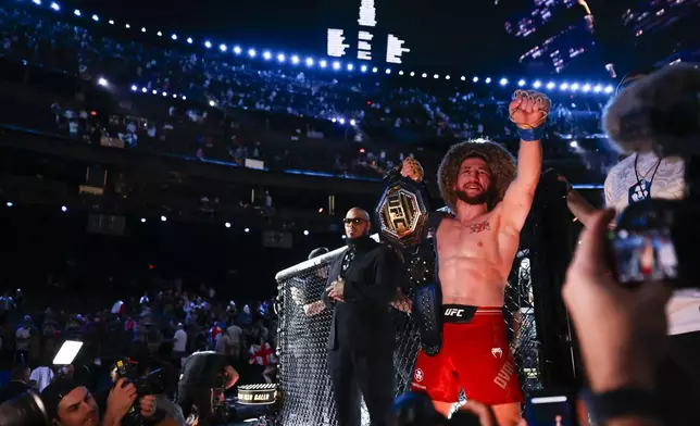 Merab Dvalishvili celebrates after defeating Sean O'Malley in a bantamweight mixed martial arts title bout during UFC 306 at the Sphere, Saturday, Sept. 14, 2024, in Las Vegas. (Wade Vandervort/Las Vegas Sun via AP)