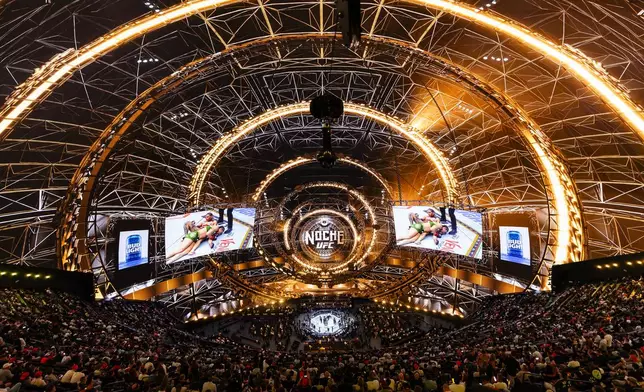 Attendees watch Yazmin Jauregui fights Ketlen Souza in a women's strawweight mixed martial arts bout during UFC 306 at the Sphere, Saturday, Sept. 14, 2024, in Las Vegas. (Wade Vandervort/Las Vegas Sun via AP)