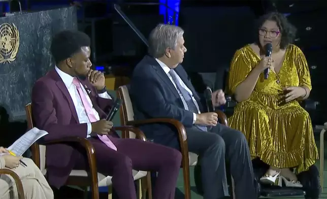 In this photo taken from video, Daphne Frias, right, engages with United Nations Secretary General Antonio Guterres, Friday, Sept. 20, 2024 during a panel discussion at UN headquarters. (UNTV via AP)