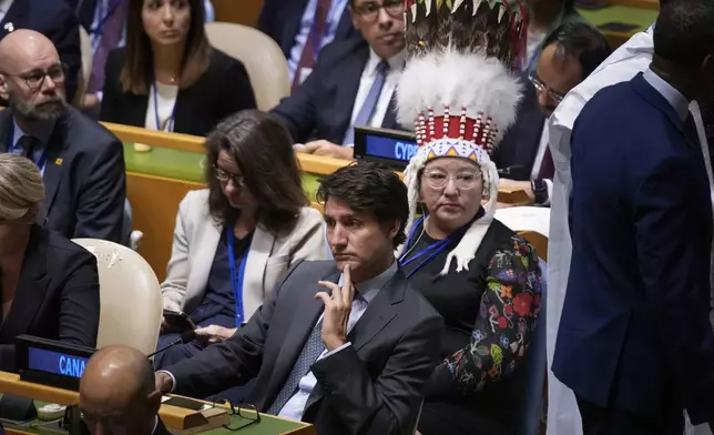 Canadian Prime Minister Justin Trudeau listens to speakers during the 79th session of the United Nations General Assembly at United Nations headquarters, Tuesday, Sept. 24, 2024. Sitting behind him is Canada's National Chief of the Assembly of First Nations Cindy Woodhouse Nepinak. (AP Photo/Seth Wenig)