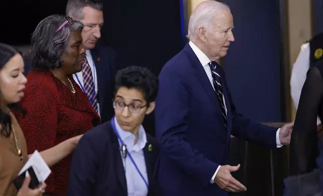 United States President Joe Biden, right, arrives for the 79th session of the United Nations General Assembly, Tuesday, Sept. 24, 2024, at UN headquarters. (AP Photo/Stefan Jeremiah)