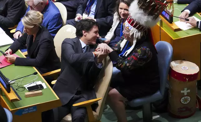 Prime Minister Justin Trudeau shakes hands with Assembly of First Nations National Chief Cindy Woodhouse Nepinak as they attend the opening of the 79th Session of the UN General Assembly at United Nations headquarters on Tuesday, Sept. 24, 2024. (Sean Kilpatrick/The Canadian Press via AP)