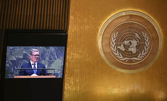 Britain's Prime Minister Keir Starmer viewed on a screen above as he addresses in person below to the 79th session of the United Nations General Assembly, Thursday, Sept. 26, 2024, at U.N. headquarters. (Leon Neal/Pool Photo via AP)