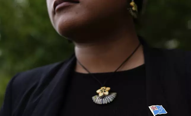 Grace Malie wears a pin of the Tuvalu flag while posing for photos, Monday, Sept. 23, 2024, at the United Nations headquarters. (AP Photo/Julia Demaree Nikhinson)
