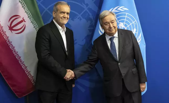 President of Iran Masoud Pezeshkian, left, and U.N. Secretary-General, Antonio Guterres shake hands at the United Nations headquarters in New York, Monday, Sept. 23, 2024. (AP Photo/Stefan Jeremiah)