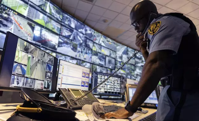 A security officer speaks on the phone inside the UN Security Operations Center inside the United Nations Headquarters, Friday Sept. 20, 2024. (AP Photo/Stefan Jeremiah)