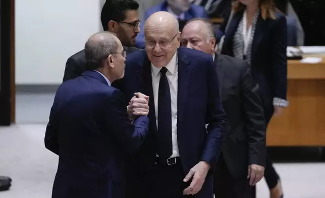 Lebanon's Prime Minister Najib Mikati, center, greets colleagues as he arrives for a Security Council meeting, Wednesday, Sept. 25, 2024, at U.N. headquarters. (AP Photo/Frank Franklin II)