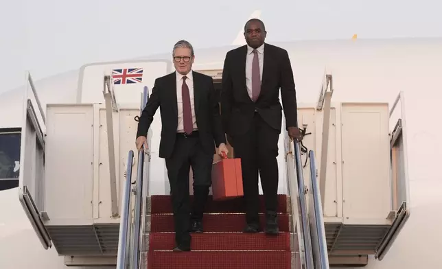 Britain's Prime Minister Keir Starmer, left, and Foreign Secretary David Lammy step from their aircraft as they arrive at Joint Base Andrews, Md., ahead of talks with U.S. President Joe Biden on resolving the conflicts in Ukraine and Gaza, Thursday, Sept. 12, 2024. (Stefan Rousseau/Pool Photo via AP)