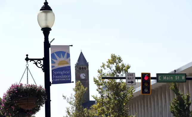 A sign hangs from a street light at the intersection of Main Street and Fountain Avenue in Springfield, Ohio, Wednesday, Sept. 11, 2024. (AP Photo/Paul Vernon)