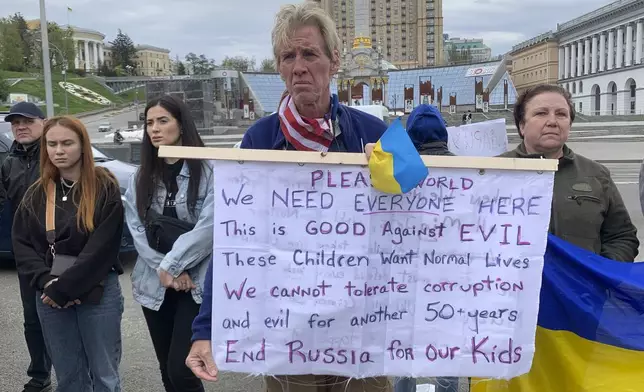 Ryan Wesley Routh holds up a banner during a rally in central Kyiv, Ukraine on Saturday April 30, 2022. (AP Photo/Alex Babenko)